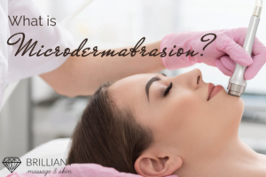 an esthetician in pink gloves doing microdermabrasion usingthe wand tool into client face: text: what is microdermabrasion