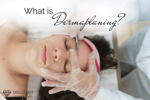 A woman lying with closed eyes while a hand in plastic gloves with scalpel doing dermaplaning on her forehead. text: what is dermaplaning?