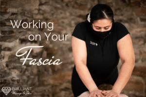 a therapist giving a client a back massage: text: working on your fascia