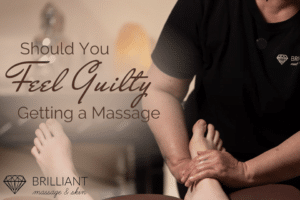 two feet having a massage: text: should you feel guilty getting a massage