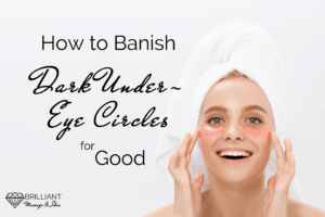 girl with white towel around her head, putting on some eye cream: text: How to banish dark under-eye circles for good
