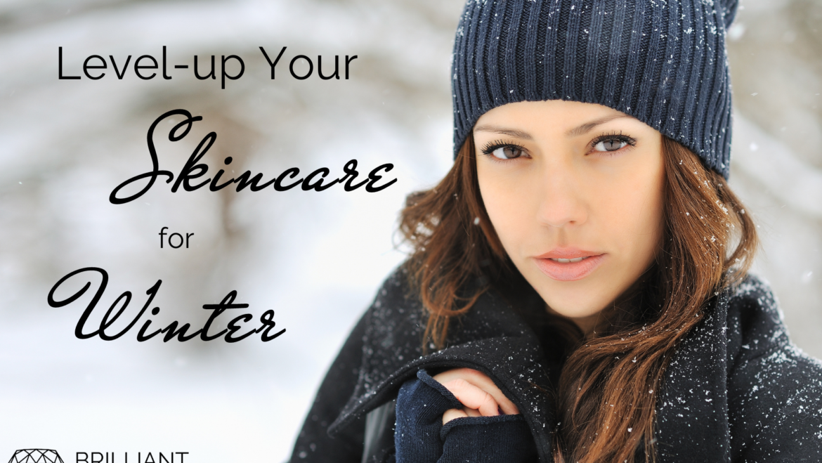 girl in black jacket and bonnet outside in snow: text: level-up your skincare for winter