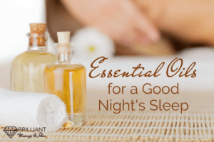 essential oils in a bottle with cork lid with white towel; text; essential oils for a good night's sleep