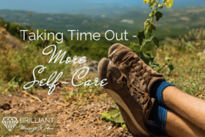 two foot in brown shoes relaxing on ground: text: taking time out- more self-care